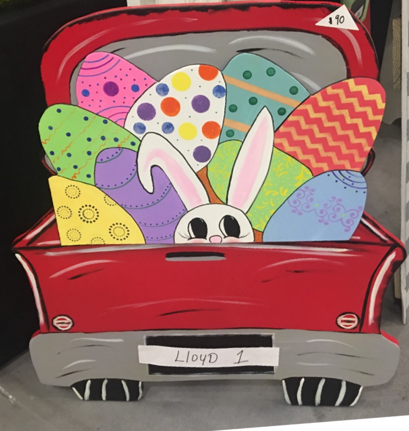 Colorful Easter-themed cutout of a truck with bunny ears and eggs on a phone screen.